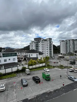 a parking lot with parked cars in a city at Wan AyuRa Homestay 2 in Tanah Rata