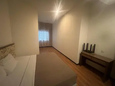 a bedroom with a white bed and a window at Iris House Resort & Apartment Cameron Highlands in Cameron Highlands