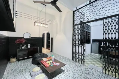 a living room with a table in a room at Homestay Taman Canning Ipoh, Perak - Smarthome in Ipoh