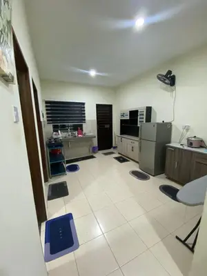 a large kitchen with a large white tile floor at Ed 01 sitiawan homestay in Sitiawan