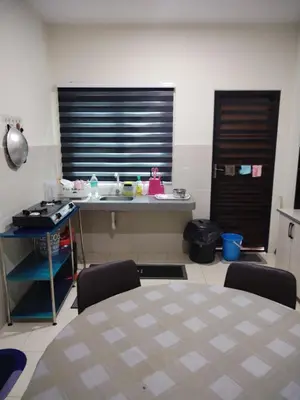 a kitchen with a table and chairs in a room at Ed 01 sitiawan homestay in Sitiawan