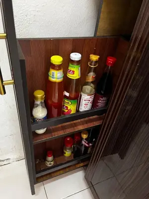 a drawer of a refrigerator filled with lots of condiments at Homestay Seri Aishah in Chemor