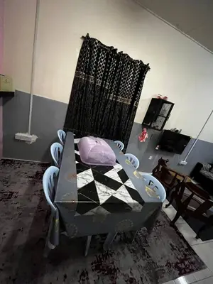 a living room with a chair in a room at Homestay Seri Aishah in Chemor