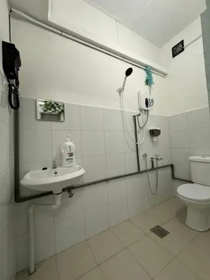 a bathroom with a shower and a sink and a toilet at Yipstay Gopeng HomeTown in Gopeng