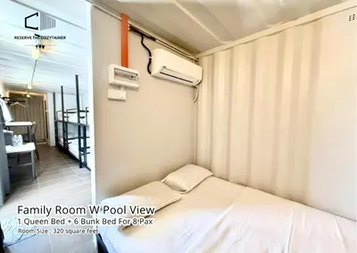 a small bedroom with a bed and a balcony at The Cozytainer in Taiping