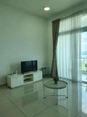 a living room with a tv and a table at Southbay Seaview Condo A23 #10minQueensbay in Bayan Lepas