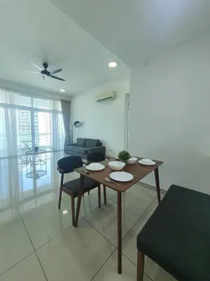 a living room with a table and chairs and a couch at Southbay Seaview Condo A23 #10minQueensbay in Bayan Lepas