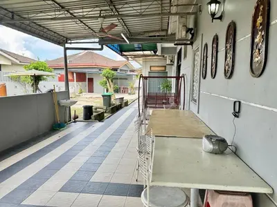 a porch with benches on the side of a building at Homestay Mohd Lee in Sungai Petani