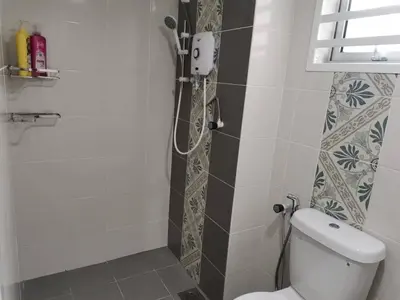 a bathroom with a toilet and a shower at myuu homestay in Ipoh