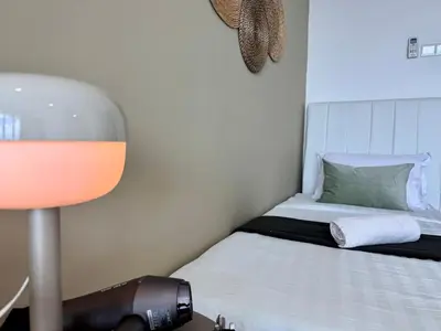 a small bedroom with a bed and a lamp at NEW-Serene Home Juru Sentral Icon City in Bukit Mertajam