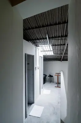 a hallway with white walls and a wooden ceiling at Aayu Pantai - George Town, Penang in George Town