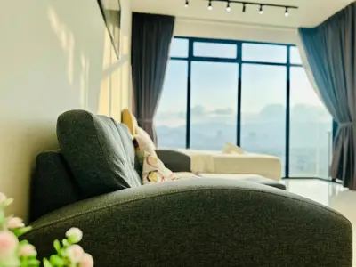 a person laying on a couch in a living room at 2BR Georgetown Luxury Suite #RooftopPool #Beacon in George Town