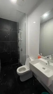 a bathroom with a sink and a toilet and a mirror at 8Pax City Centre 2BR 3km to Komtar in George Town