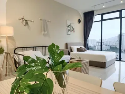 a bedroom with a bed and a table with a plant at 8Pax City Centre 2BR 3km to Komtar in George Town