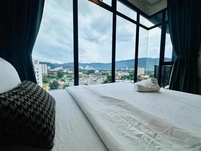 a bedroom with a bed with a view of a city at Comfy 2BR Sunny Suite Sky Pool & Stunning Views in George Town