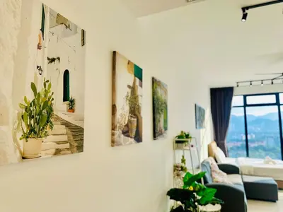 a living room with paintings on the wall at Elegant 2BR Luxury Suite in Haaven in George Town