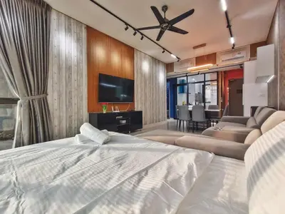 a bedroom with a bed and a living room at Fresh, Modern Georgetown Suite with Sky Pool Views in George Town