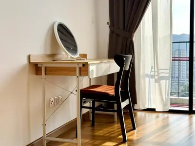a desk with a mirror and a chair next to a window at Luxury 2BR SunnySuite Sky Pool Breathtaking Views in George Town