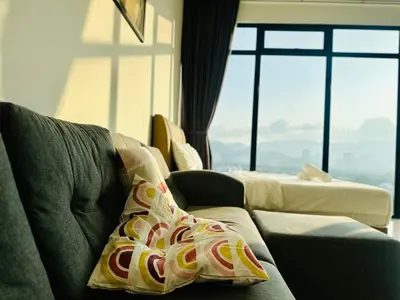a living room with a couch and a large window at Spacious 2BR Suite for 5-7 pax in George Town