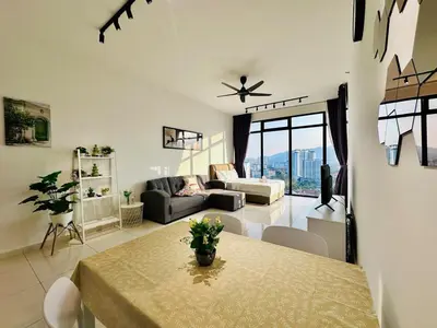 a living room with a table and a couch at Spacious 2BR Suite for 5-7 pax in George Town