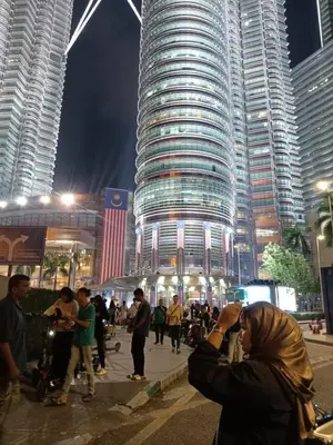 a man taking a picture of a tall building at Muhammad Najmi Hakim Bin Abdullah in Kampar