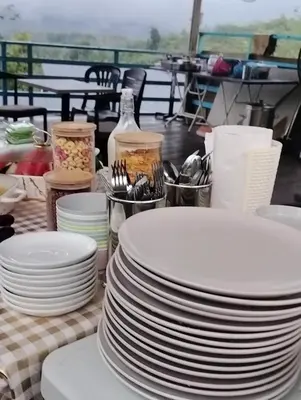 a stack of white plates sitting on a table at CBHResort Agrofarm in Kampong Benchah Tualang