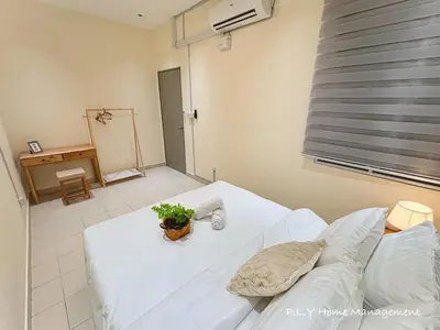 a bedroom with a white bed with a plant on it at Falim Residence Condo Ipoh with 2 Parking in Ipoh