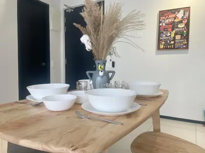 a wooden table with bowls and a vase on it at Tom and Jerry Suite with Infinity Pool in George Town