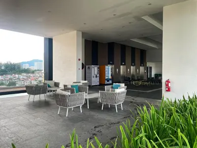 a lobby with chairs and tables on a balcony at Tom and Jerry Suite with Infinity Pool in George Town