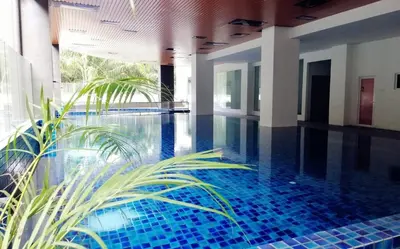 a swimming pool with blue tiles in a building at Venus Home 3Room Pool,PlayGround,Free Wifi,6Pax in Seri Manjung