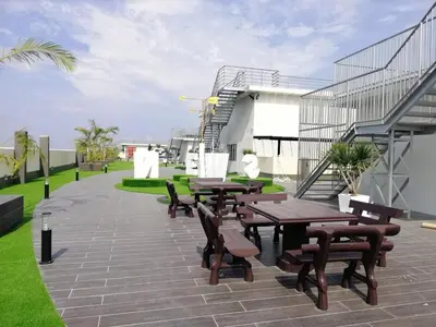 a patio with wooden tables and chairs and stairs at Venus Home 3Room Pool,PlayGround,Free Wifi,6Pax in Seri Manjung