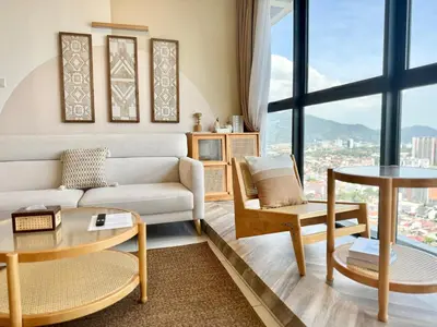 a living room with a couch and a table at Urban Suites Jelutong #Highfloor Seaview #Water dispenser #Infinity Pool #5pax #3BR2bath #2Queen1Single #Quality well maintained #Private host in Jelutong