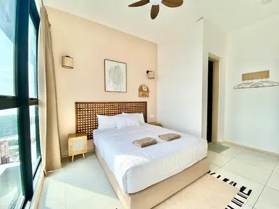 a bedroom with a large bed with white sheets at Urban Suites Jelutong #Highfloor Seaview #Water dispenser #Infinity Pool #5pax #3BR2bath #2Queen1Single #Quality well maintained #Private host in Jelutong
