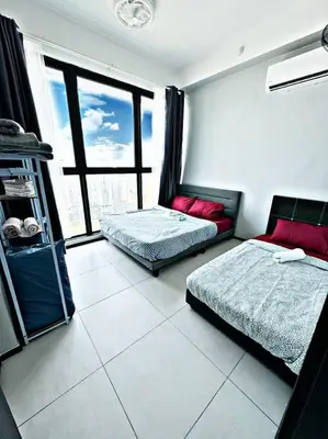 a bedroom with two beds and a large window at World Class Apartment In Georgetown 3BR 10pax in Jelutong
