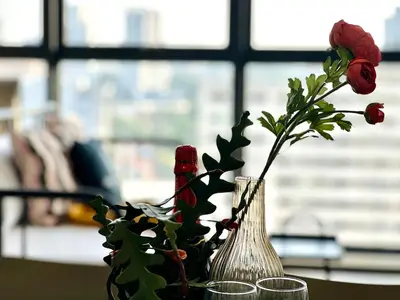 a vase with flowers in it sitting on a table at Spacious 3BR Infinity Pool 10pax,Groups & Families 10pax in George Town