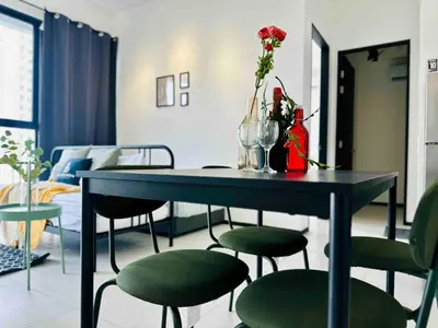 a table and chairs with vases and flowers on it at Familystay Home 3BR-10PAX Urban suites in George Town
