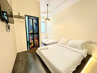 a room with a bed and a painting on the wall at Bahari 58 in George Town