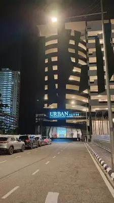 a building with cars parked in a parking lot at night at Charming Haven- Relaxing Retreat Nearby Airpor 10pax in George Town