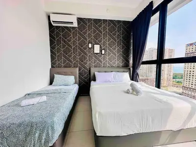 two beds in a room with a window at newly renovation apartment 3BR pool 10 pax in George Town