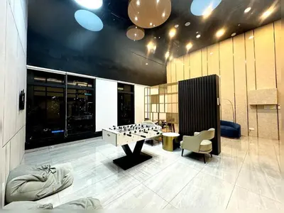 a room with a foosball table and a chair at cozy luxury suites urban in penang city view 10pax in George Town