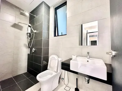 a bathroom with a white toilet and a sink at cozy luxury suites urban in penang city view 10pax in George Town