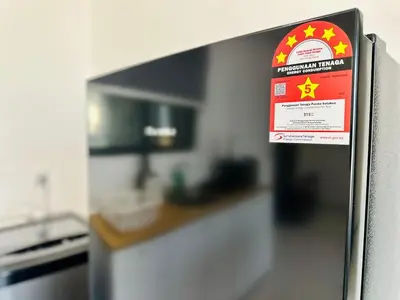 a sign on the side of a refrigerator in a kitchen at Sea View Condo In Georgetown 10 pax in George Town