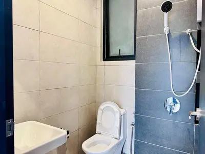 a bathroom with a toilet and a sink and a shower at Sea View Condo In Georgetown 10 pax in George Town