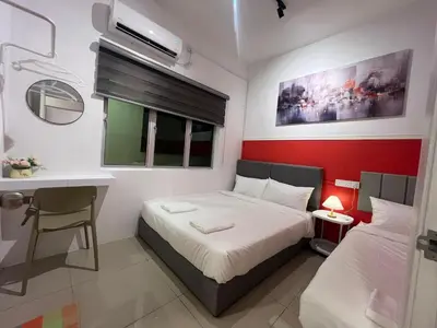 a bedroom with a bed and a desk and a window at RedHouse Sky Garden Klabang 10 pax in Chemor