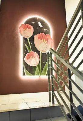 a mural of pink flowers on a wall at TheFloral Penthouse Night Market Wifi & Netflix in Brinchang