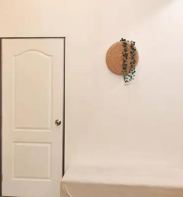 a white door with a wreath hanging on a wall at TheFloral Penthouse Night Market Wifi & Netflix in Brinchang