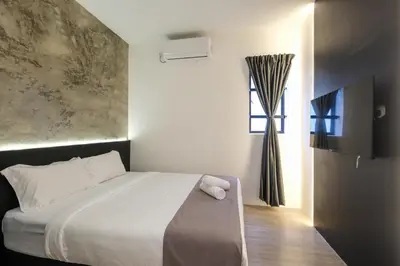 a bedroom with a white bed and a window at Loft 82 in Bukit Mertajam