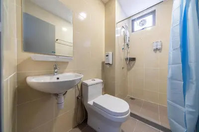 a bathroom with a toilet and a sink at Royo Homestay in Palas Horizon in Brinchang