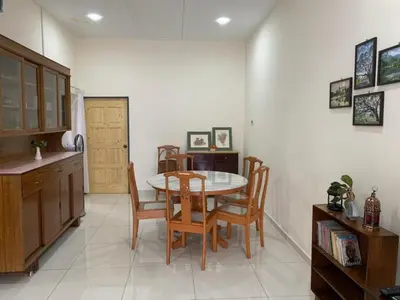 a kitchen and dining room with a table and chairs at Aloe Vera Homestay - 3 Bed Rooms Corner House in Kamunting