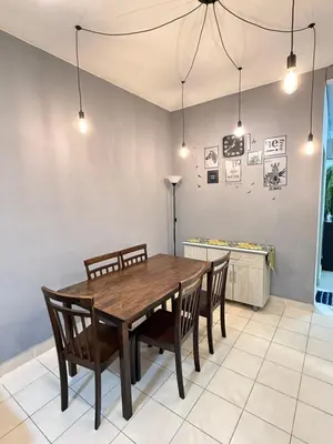 a dining room with a wooden table and chairs at AYAAN CLUB HOUSE Free WiFI & Netflix in Cameron Highlands